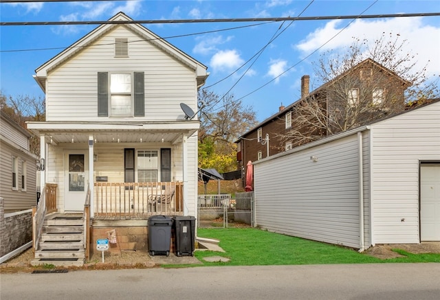 view of front of house with covered porch and a front yard