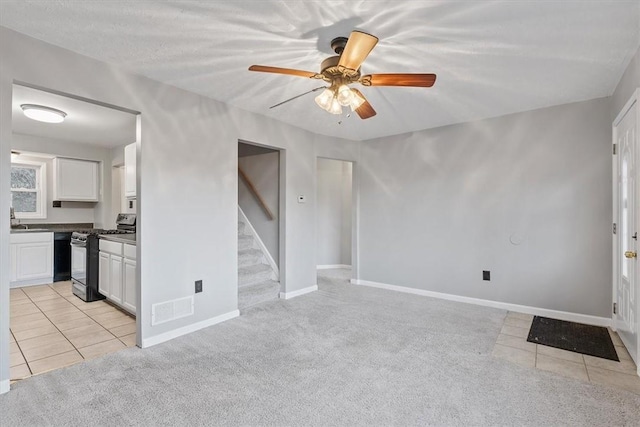 190 Pine Creek Rd, Mccandless, PA 15090 - unfurnished living room featuring light tile patterned floors, a ceiling fan, light carpet, and stairs