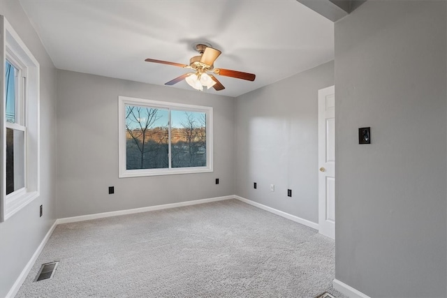 empty room featuring carpet floors and ceiling fan