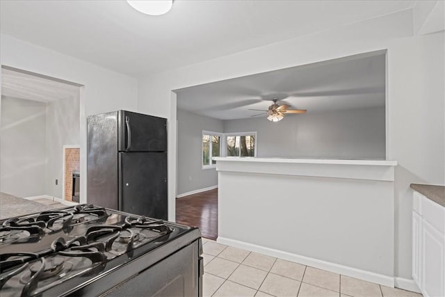 190 Pine Creek Rd, Mccandless, PA 15090 - kitchen featuring range with gas stovetop, freestanding refrigerator, ceiling fan, baseboards, and light tile patterned floors