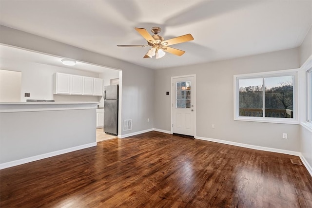 unfurnished living room featuring ceiling fan and hardwood / wood-style floors