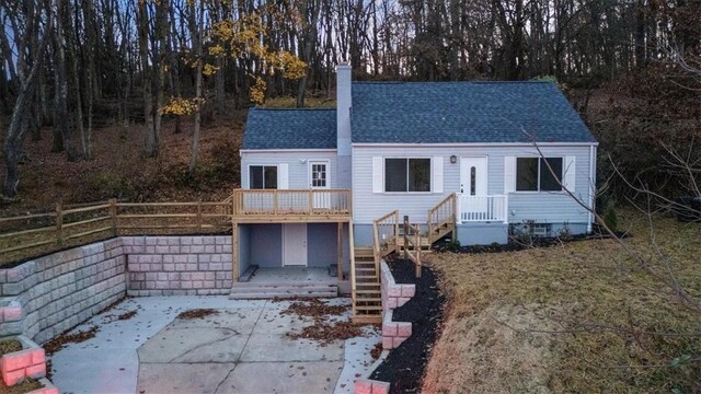 190 Pine Creek Rd, Mccandless, PA 15090 - view of front of house with a shingled roof, fence, a chimney, a patio, and a wooden deck