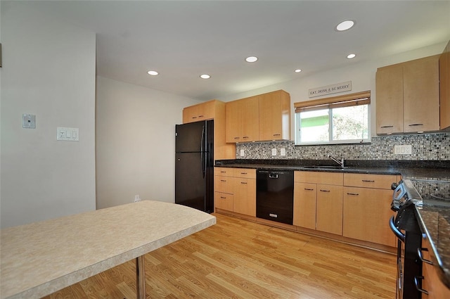 kitchen with black appliances, light brown cabinets, light hardwood / wood-style floors, and sink