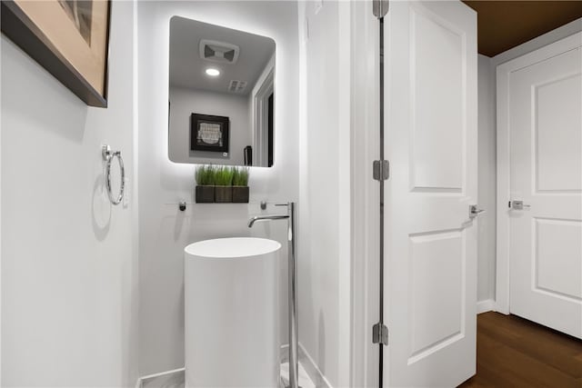 bathroom with hardwood / wood-style flooring