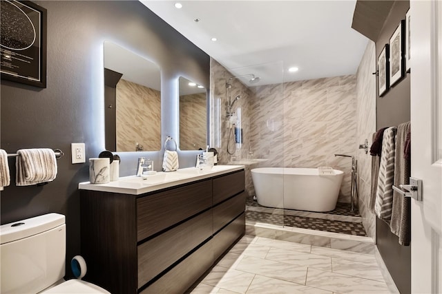 bathroom with a bathtub, vanity, tile walls, and toilet