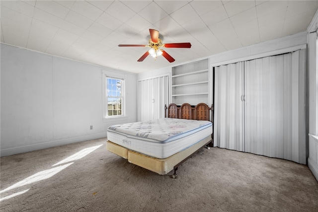 bedroom with ceiling fan, carpet floors, and ornamental molding