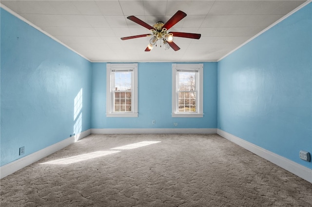 unfurnished room featuring ceiling fan, carpet floors, and ornamental molding