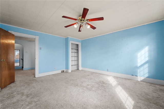 unfurnished bedroom featuring multiple windows, carpet floors, and ceiling fan