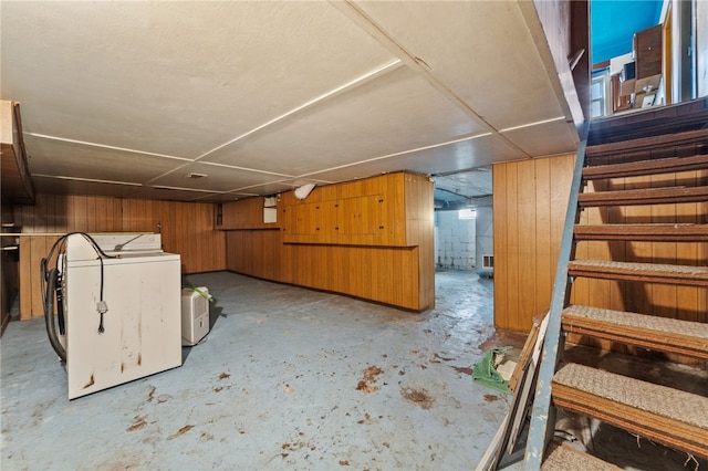 basement featuring washer / clothes dryer and wood walls