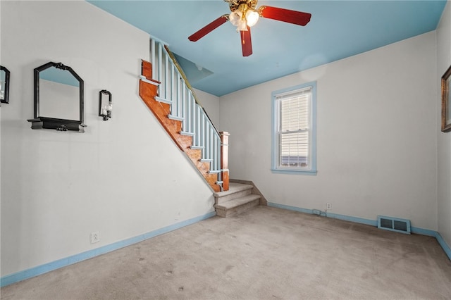 unfurnished living room featuring carpet and ceiling fan