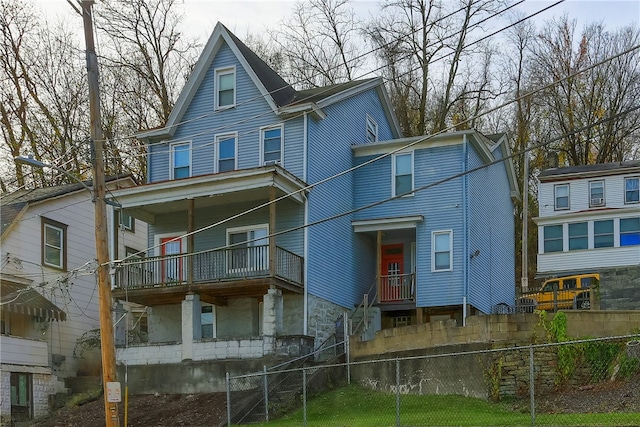 rear view of property featuring a balcony