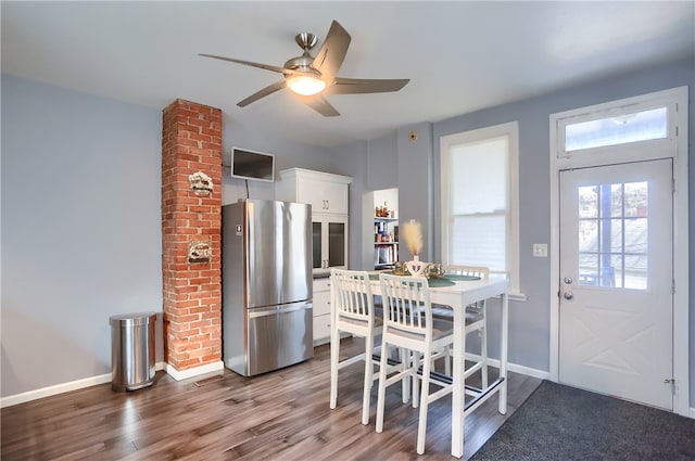 dining area featuring wood-type flooring and ceiling fan