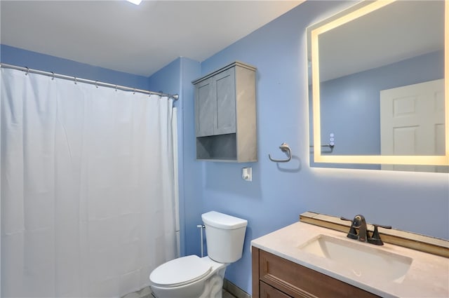 bathroom featuring vanity, toilet, and curtained shower