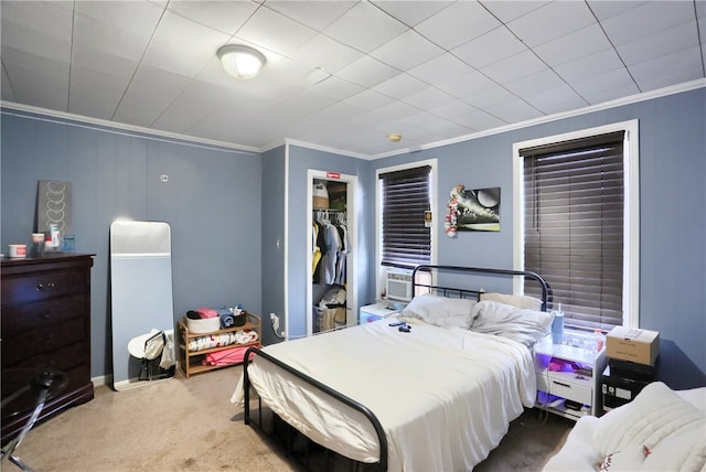 carpeted bedroom featuring cooling unit, crown molding, and a closet