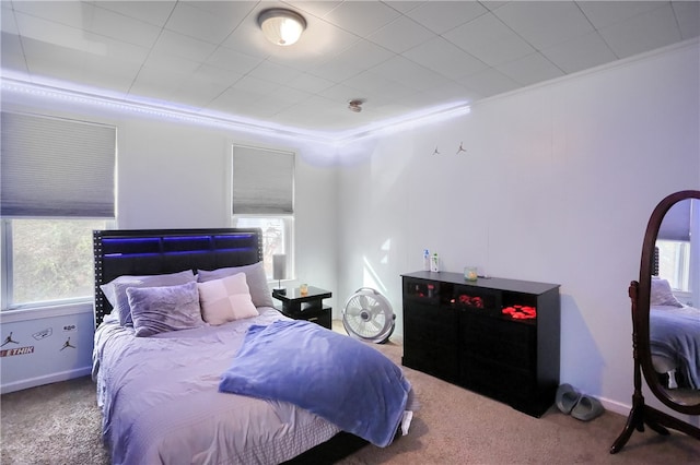 bedroom with carpet floors and crown molding