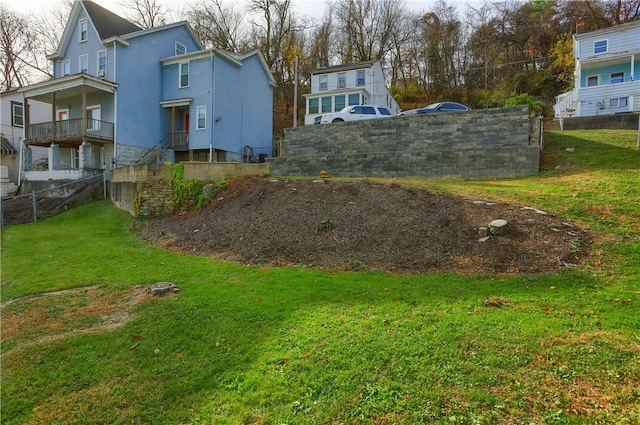 view of yard with a balcony