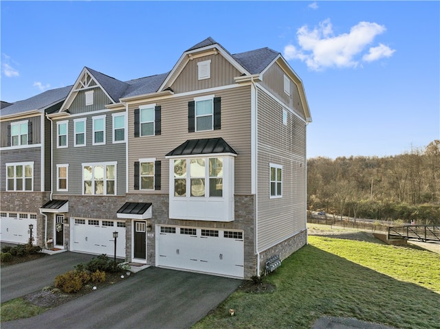 multi unit property featuring a front yard and a garage