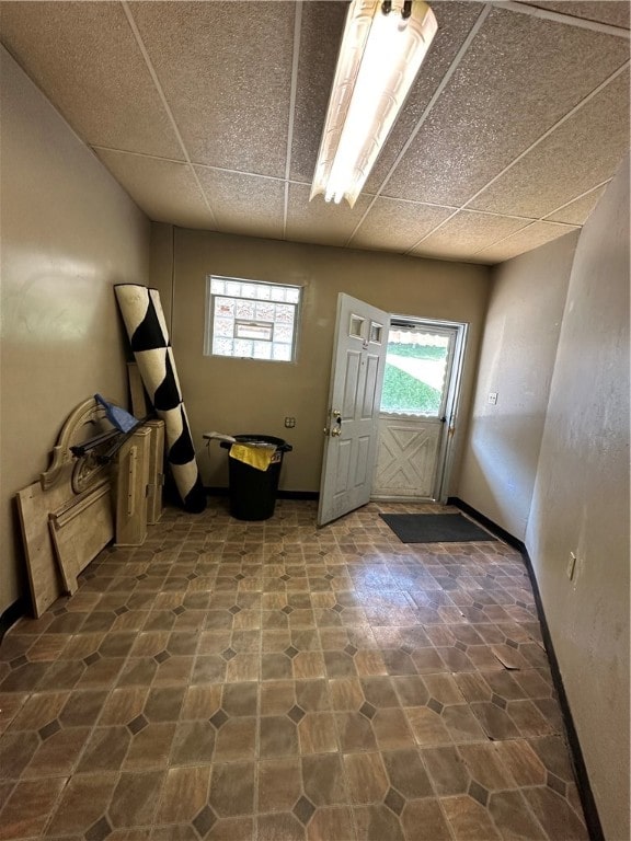 foyer entrance with a paneled ceiling