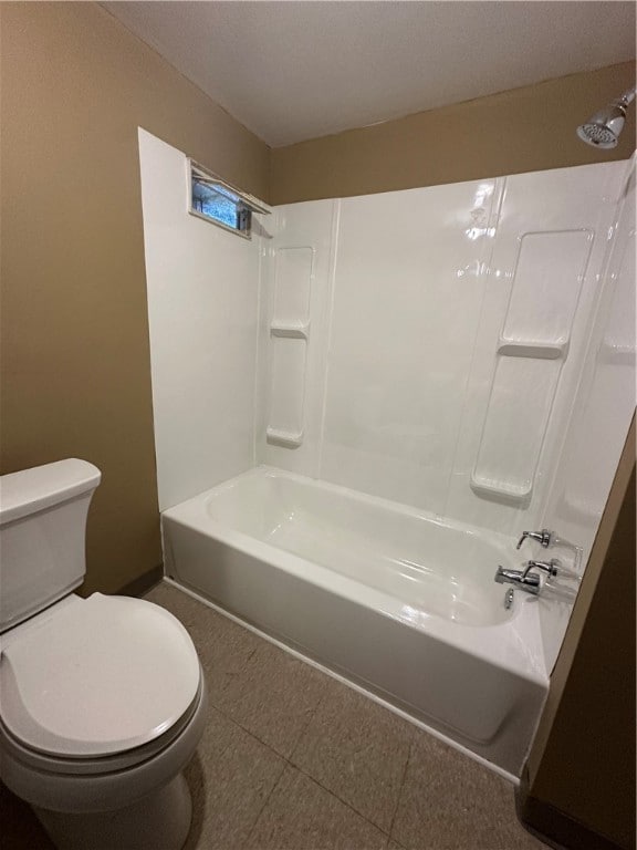 bathroom with tile patterned floors, toilet, and shower / washtub combination