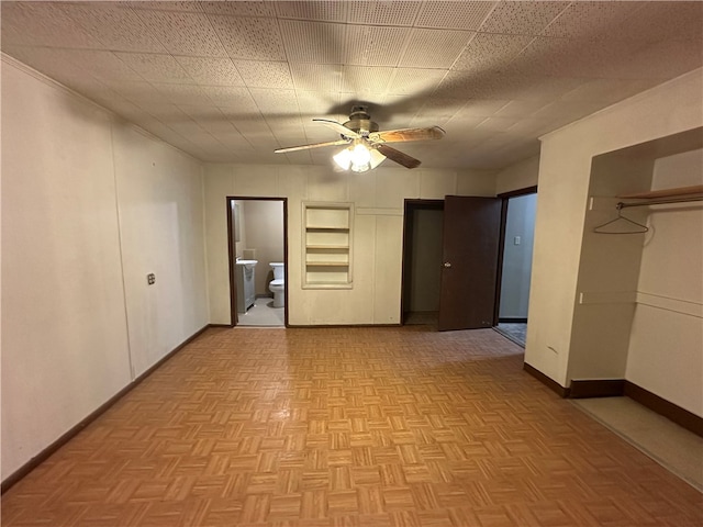 empty room featuring ceiling fan and light parquet flooring