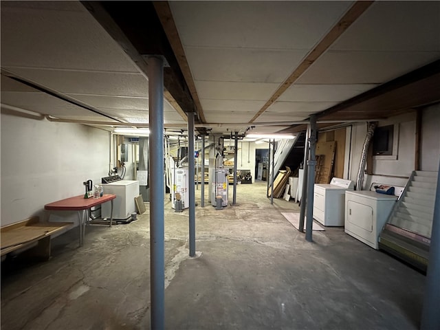 basement featuring water heater and independent washer and dryer