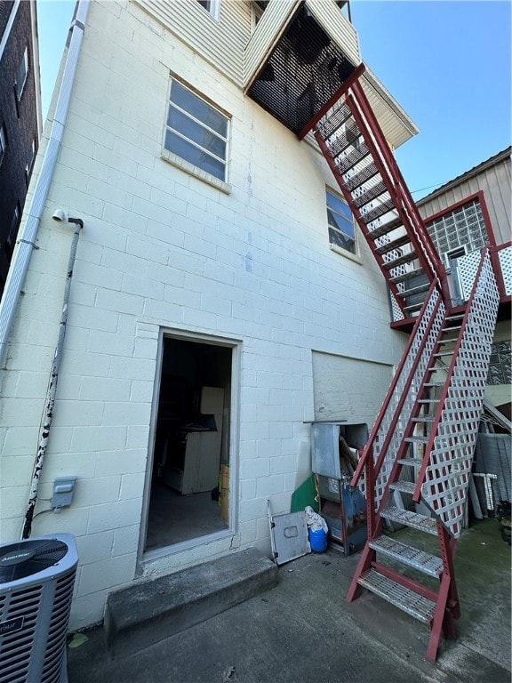 back of property featuring central AC unit