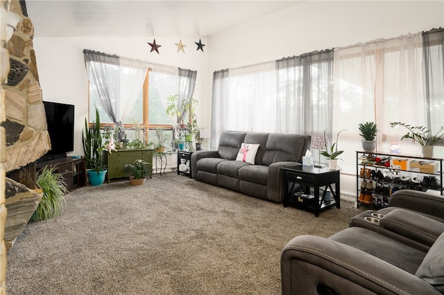 carpeted living room featuring vaulted ceiling