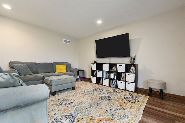 living room with dark hardwood / wood-style flooring