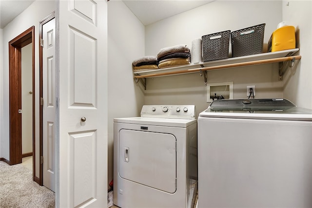 laundry area featuring washer and dryer and light carpet