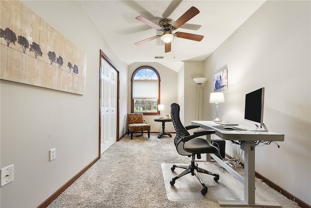 carpeted home office with ceiling fan and vaulted ceiling