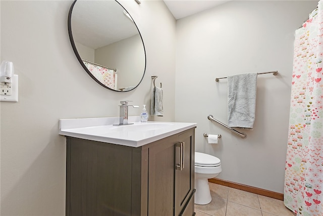 bathroom with tile patterned floors, vanity, toilet, and walk in shower