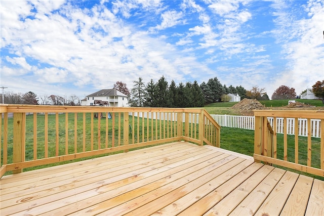 wooden terrace featuring a yard