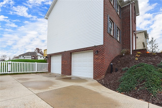 view of side of home featuring a garage