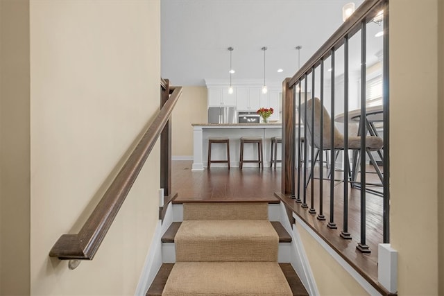 stairs featuring wood-type flooring