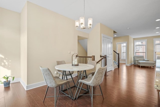 dining room with a chandelier and dark hardwood / wood-style floors