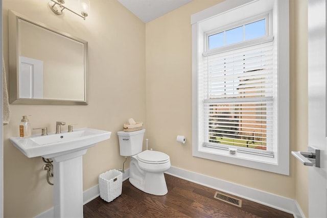 bathroom with hardwood / wood-style floors, toilet, and sink