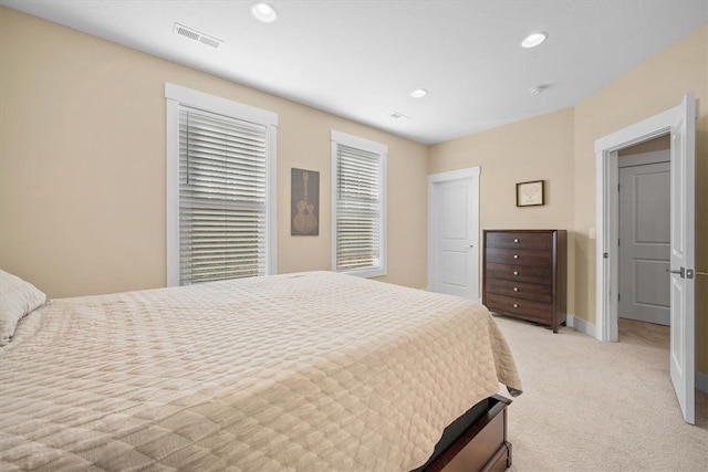 bedroom featuring light carpet