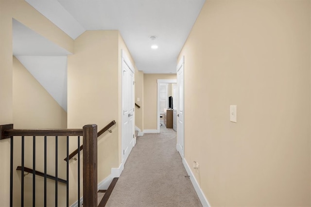 hallway featuring light carpet