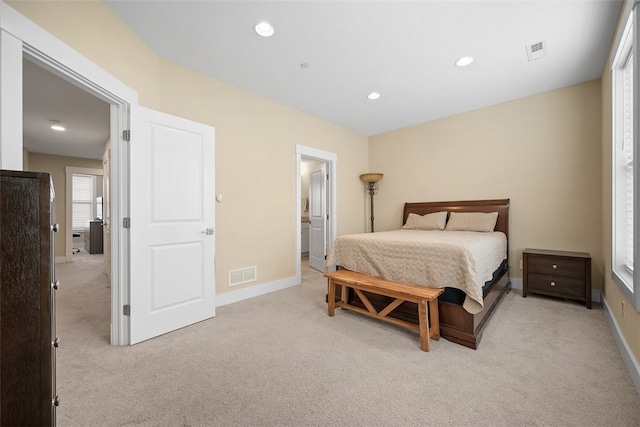 carpeted bedroom with ensuite bath