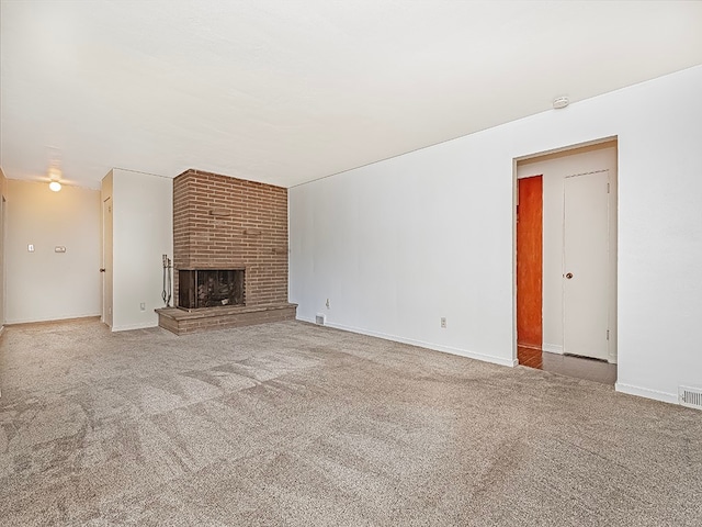 unfurnished living room featuring carpet flooring and a fireplace