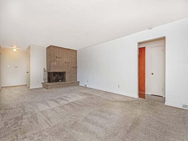 316 Jefferson, Verona, PA 15147 - unfurnished living room with carpet, a brick fireplace, and baseboards