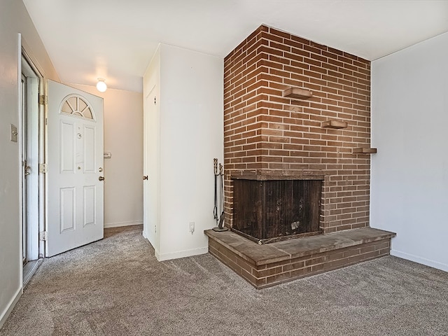 unfurnished living room with carpet floors and a brick fireplace