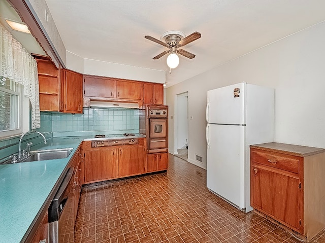 kitchen with backsplash, stainless steel appliances, ceiling fan, and sink