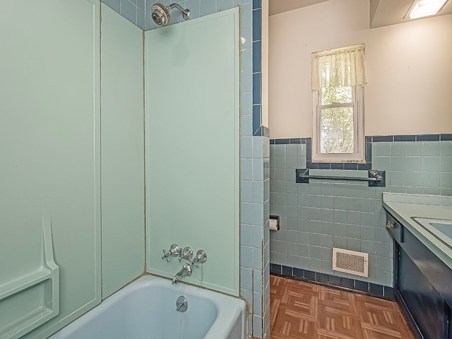 bathroom featuring vanity, parquet floors, and tile walls