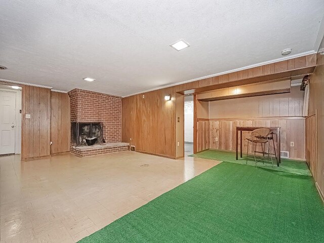 316 Jefferson, Verona, PA 15147 - finished basement with wooden walls, a textured ceiling, a brick fireplace, tile patterned floors, and crown molding