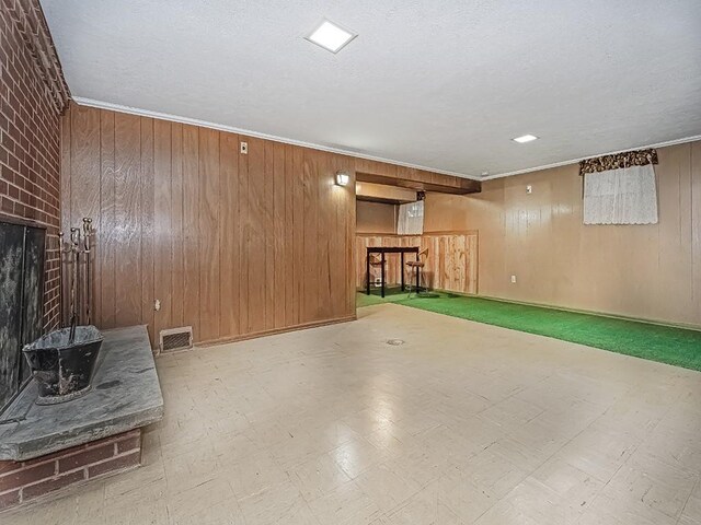316 Jefferson, Verona, PA 15147 - basement with wooden walls, a brick fireplace, and a textured ceiling