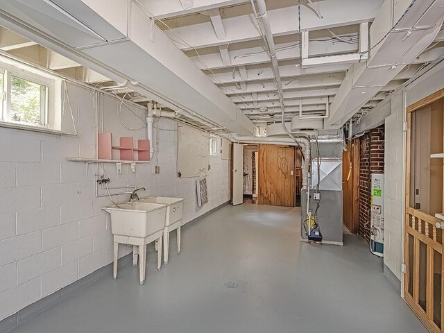316 Jefferson, Verona, PA 15147 - below grade area featuring heating unit, gas water heater, and concrete block wall
