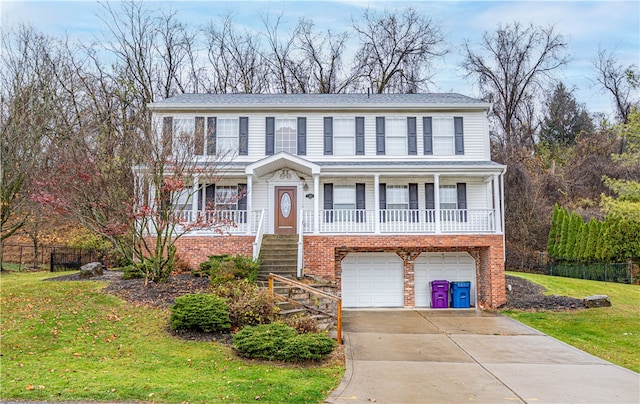 view of front facade featuring covered porch, a garage, and a front lawn