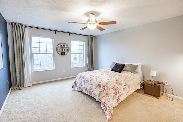 bedroom with carpet flooring, ceiling fan, and a textured ceiling