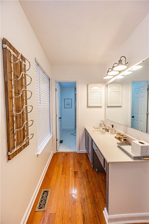 bathroom featuring vanity and hardwood / wood-style flooring